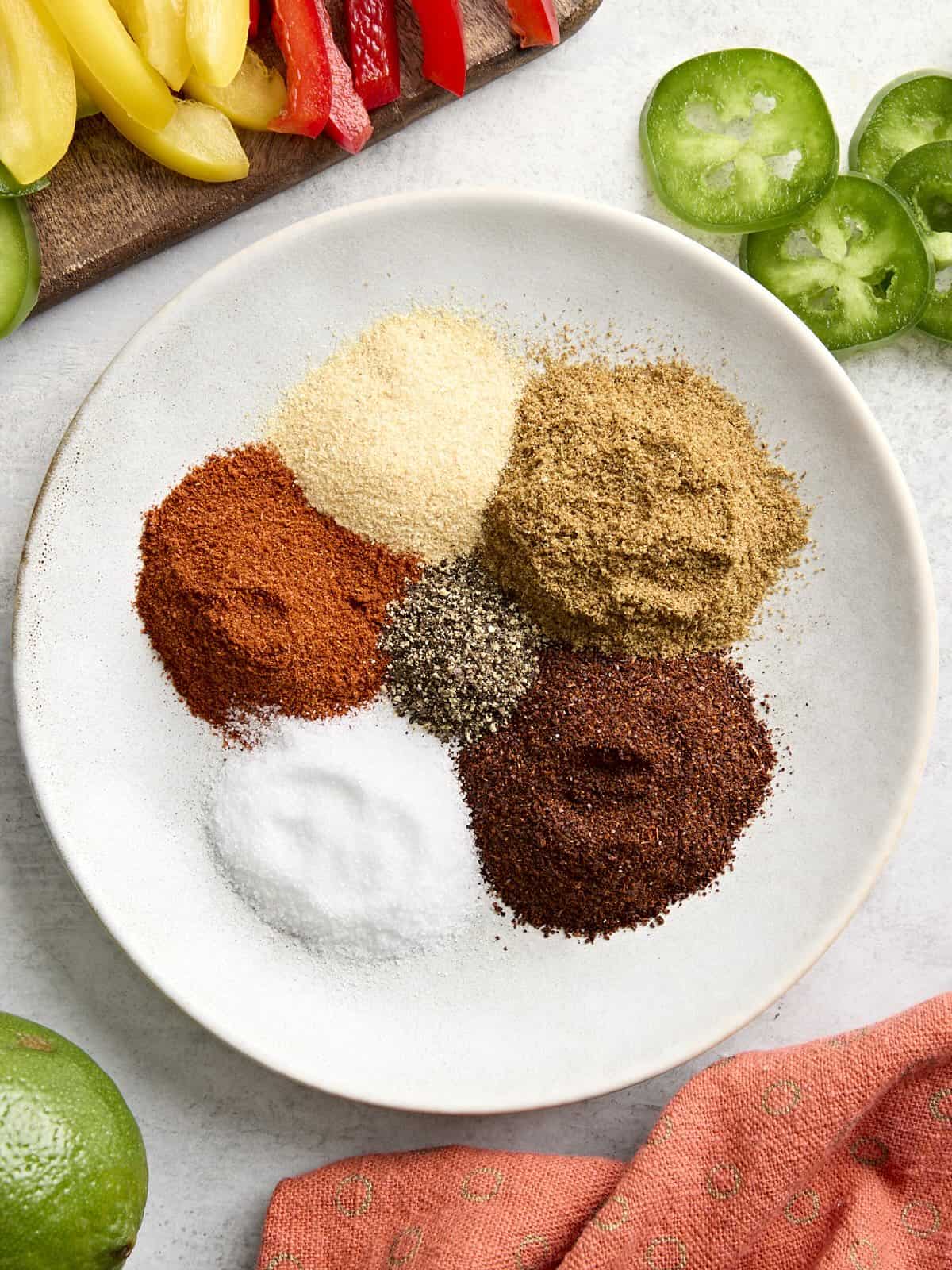 Ingredients for homemade fajita seasoning on a plate.