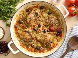 Overhead view of Greek chicken and orzo in a skillet.