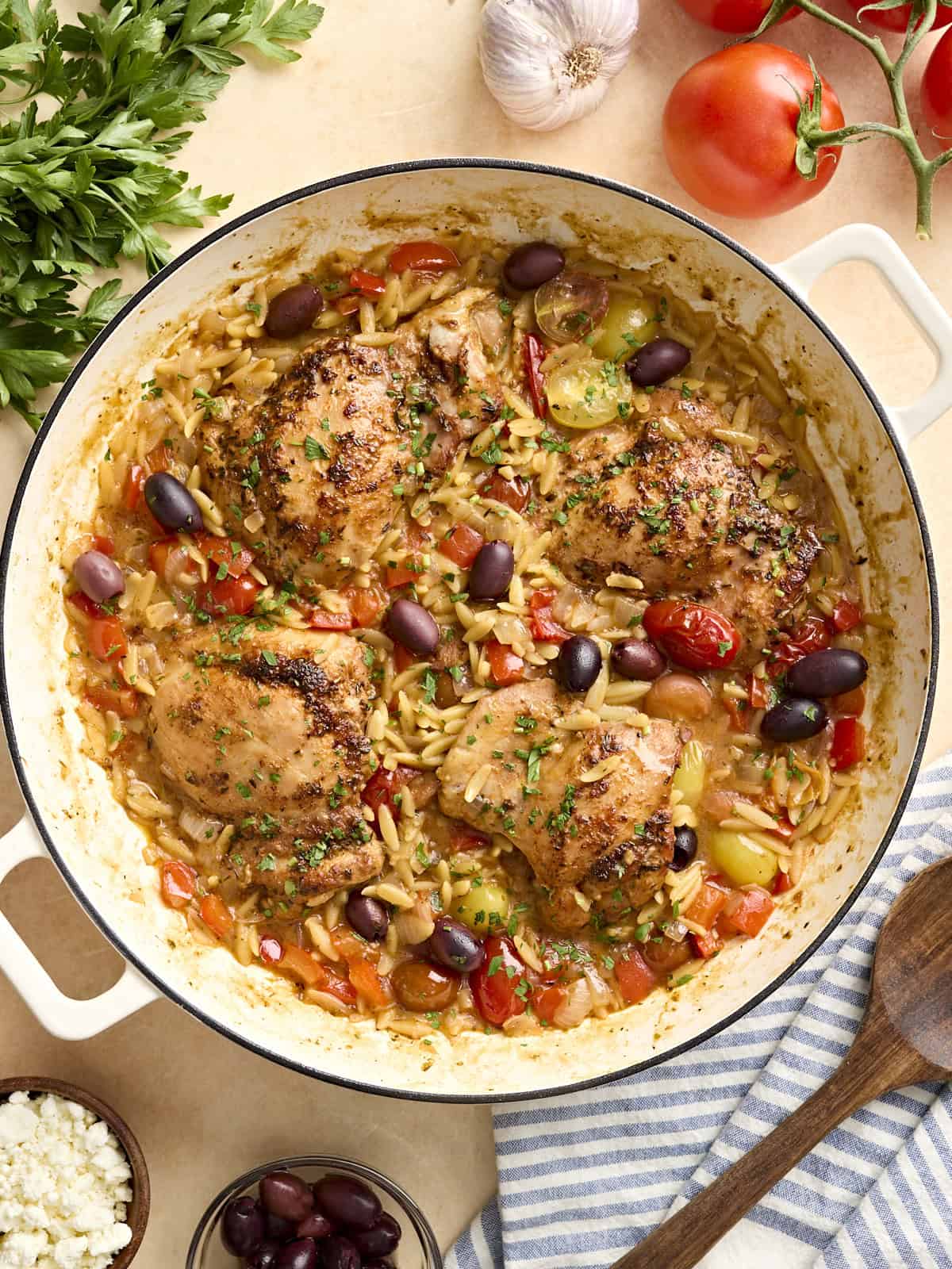 Overhead view of Greek chicken and orzo in a skillet.