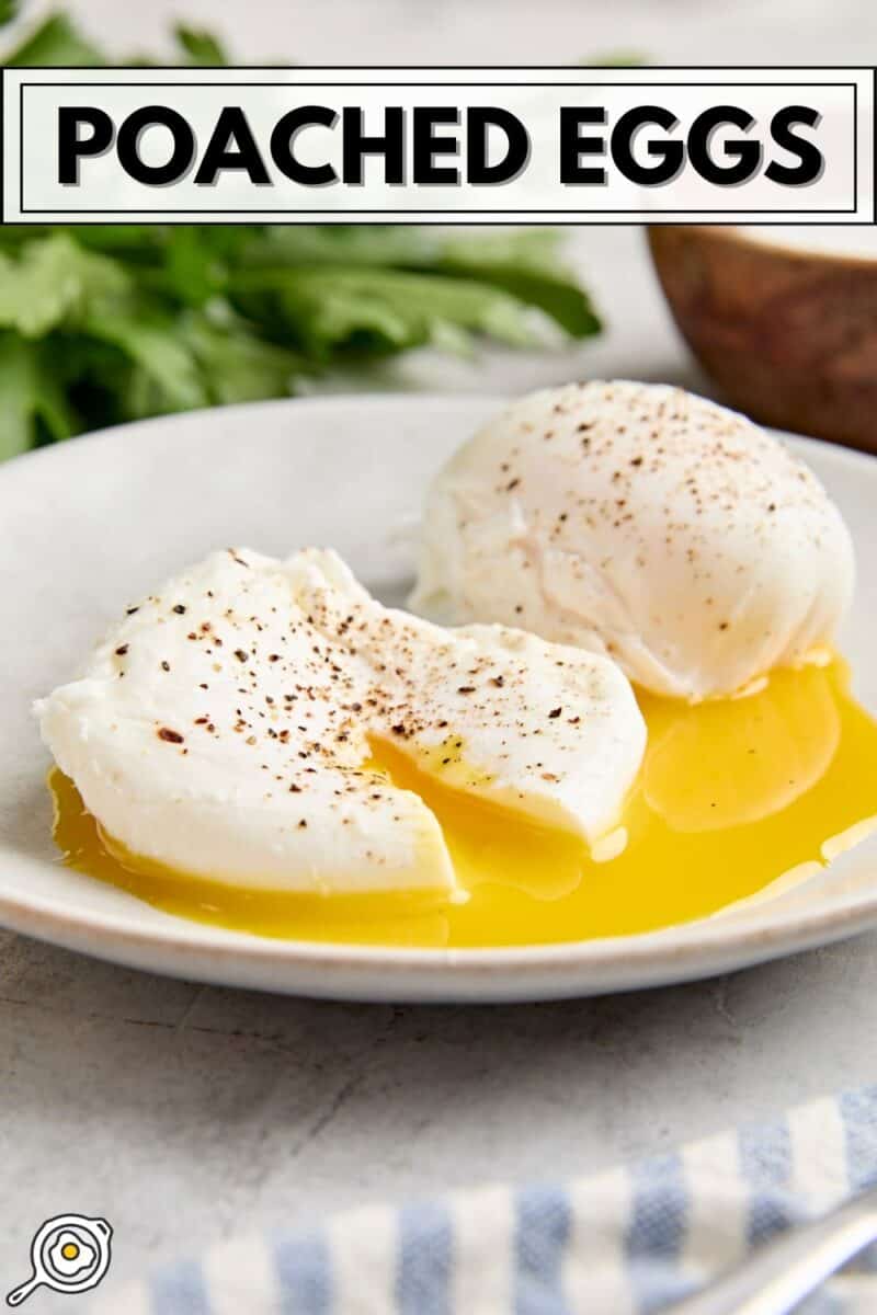 Side view of two poached eggs on a plate, with one cut open and the yolk running from it.