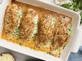 Overhead view of spinach stuffed chicken breasts in a baking dish.