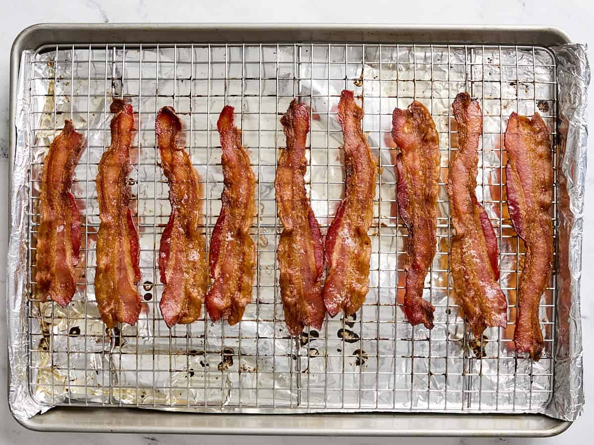 Cooked bacon on a wire rack.