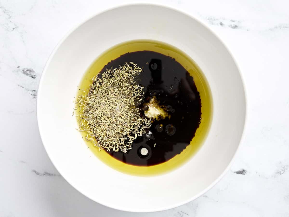 Olive oil, soy sauce, Worcestershire sauce, garlic, balsamic vinegar, and seasonings in a bowl.