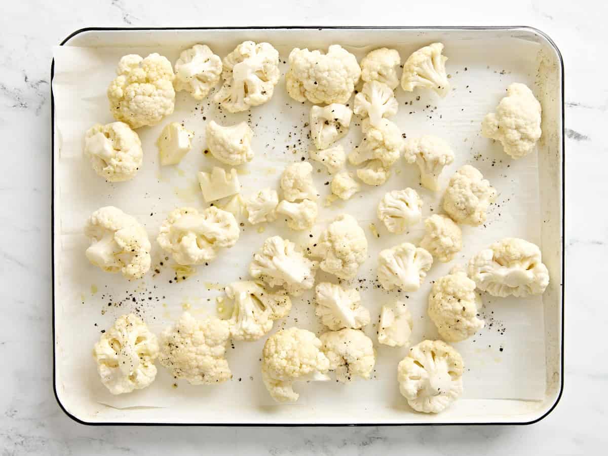 overhead view of roasted cauliflower with salt and pepper