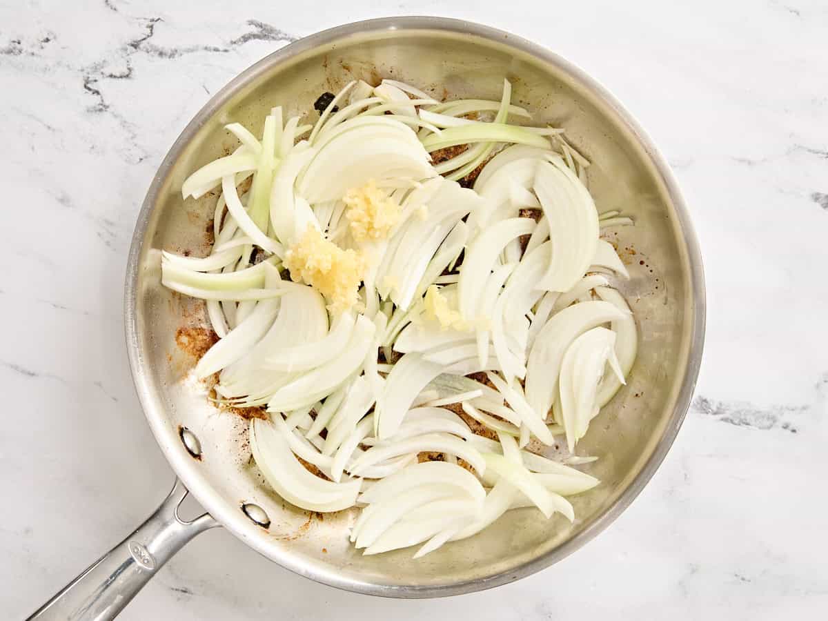 Sliced onion and minced garlic in a skillet.