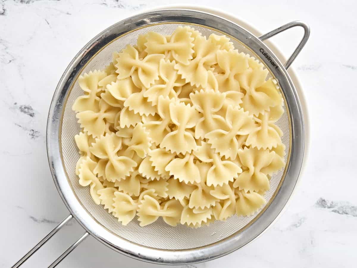 Bow tie pasta in a strainer.