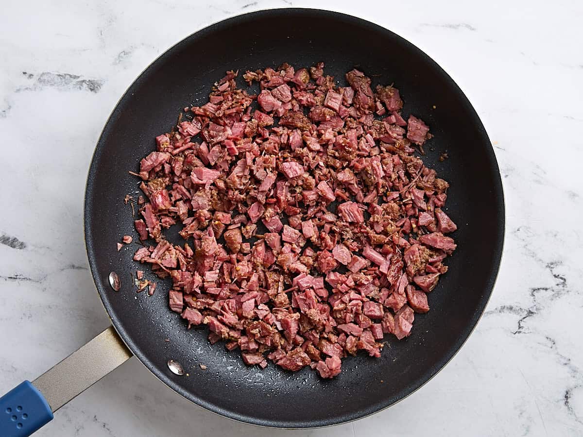 Chopped corned beef in a skillet.