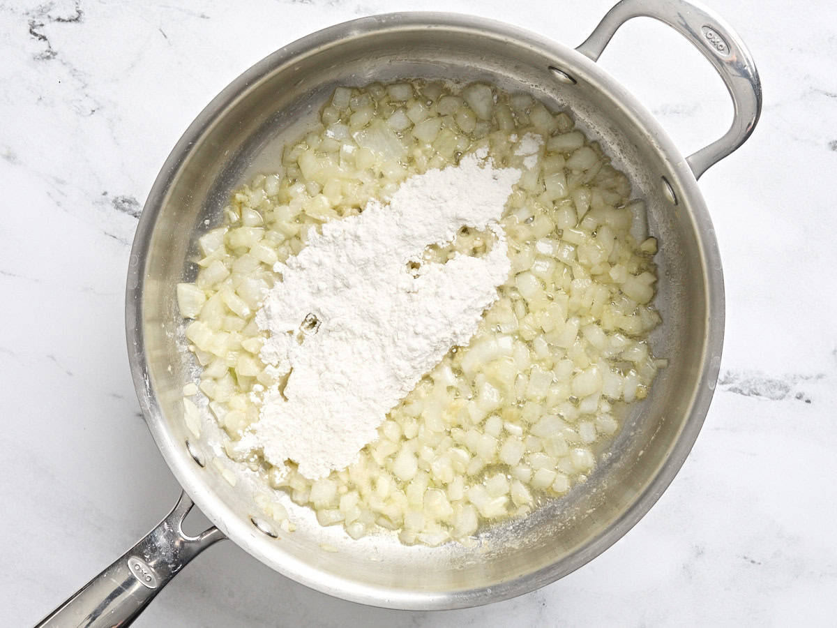 Flour added to diced onions and butter in a skillet.