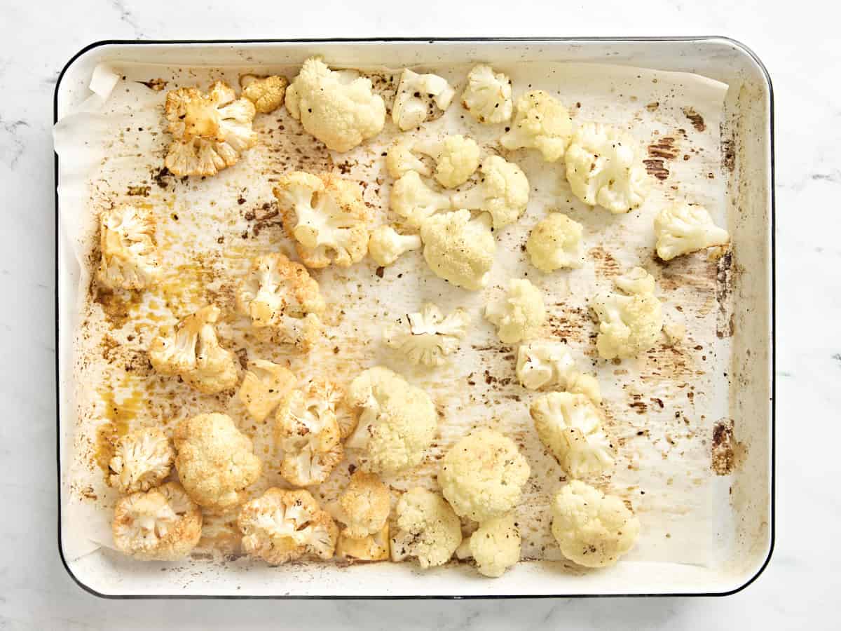 overhead view of roasted cauliflower with added hot sauce