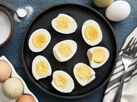 Overhead view of air fryer hard boiled eggs on a plate.