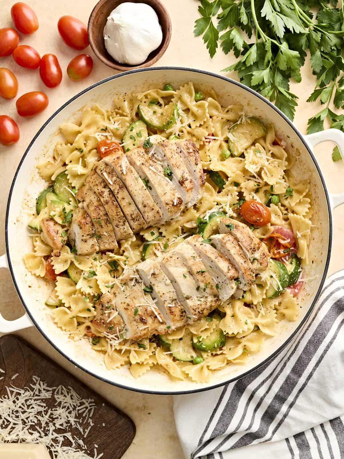 Overhead view of Pasta Primavera with chicken in a skillet.