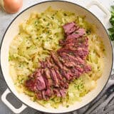 Overhead view of corned beef and cabbage in a skillet.