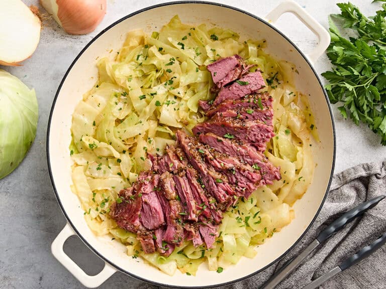 Overhead view of corned beef and cabbage in a skillet.