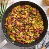 Overhead view of corned beef hash in a skillet.