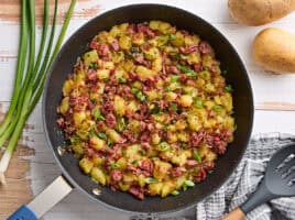 Overhead view of corned beef hash in a skillet.