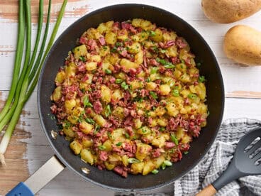 Overhead view of corned beef hash in a skillet.