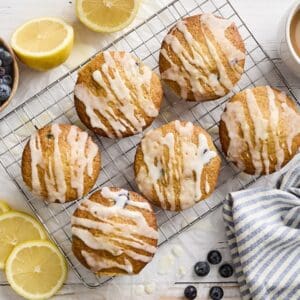 Overhead view of lemon blueberry muffins on a wire rack.