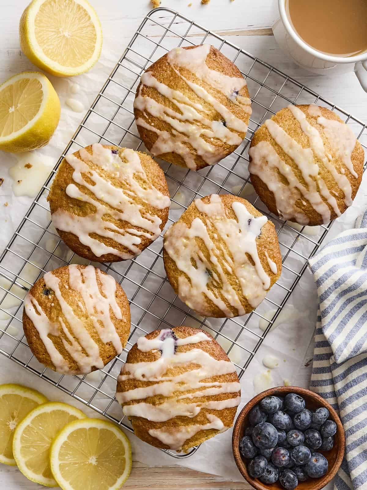 Overhead view of blueberry lemon muffins on a wire rack.