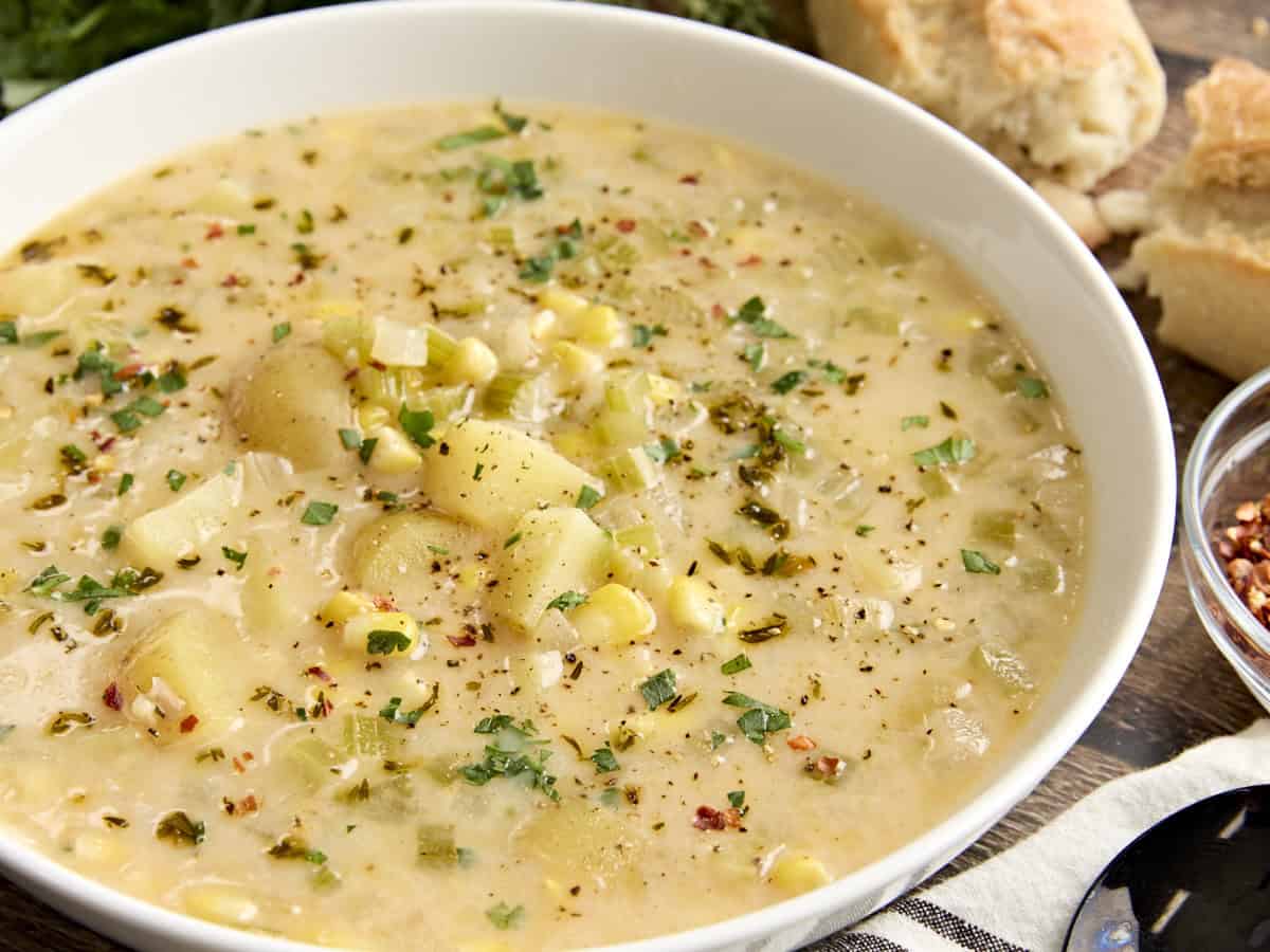 Side close up view of a bowl of potato corn chowder.