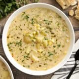 Overhead view of a bowl of potato corn chowder.