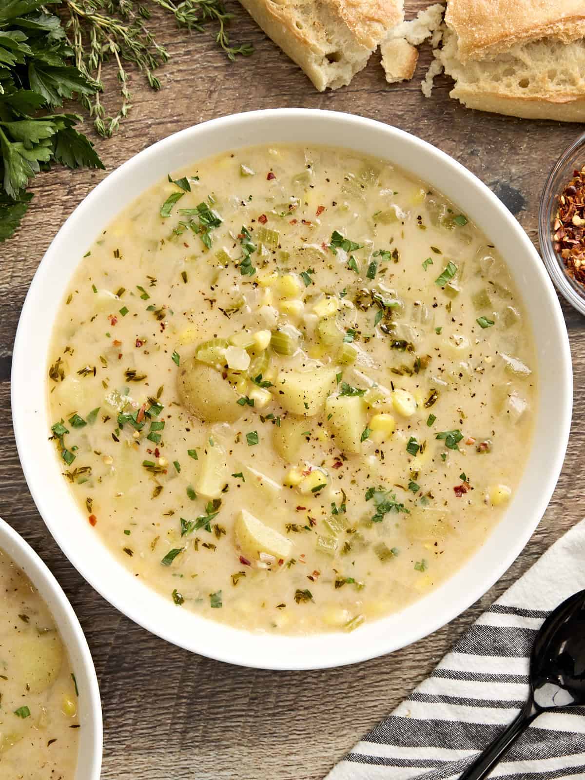 Overhead view of a bowl of potato corn chowder.