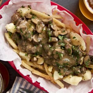 Overhead view of poutine in a red basket.