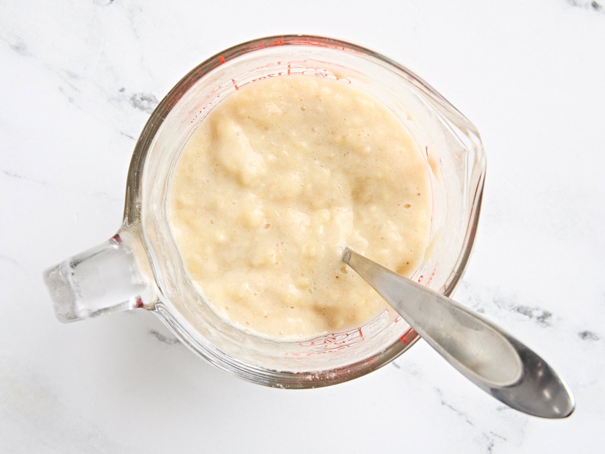 Mashed bananas in a glass jug.