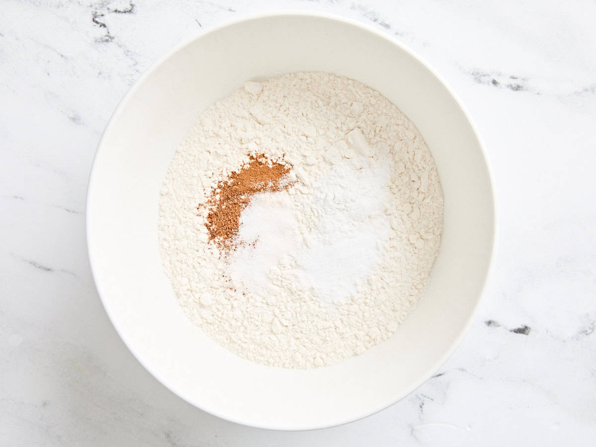 Flour, baking soda, baking powder, and spices in a bowl.