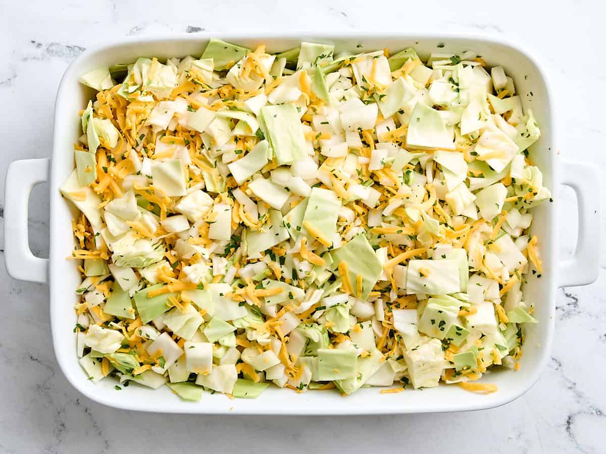 The ingredients for cabbage casserole in a casserole dish after being combined.