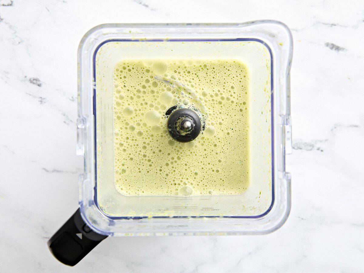 Asparagus soup in a blender after being blended.