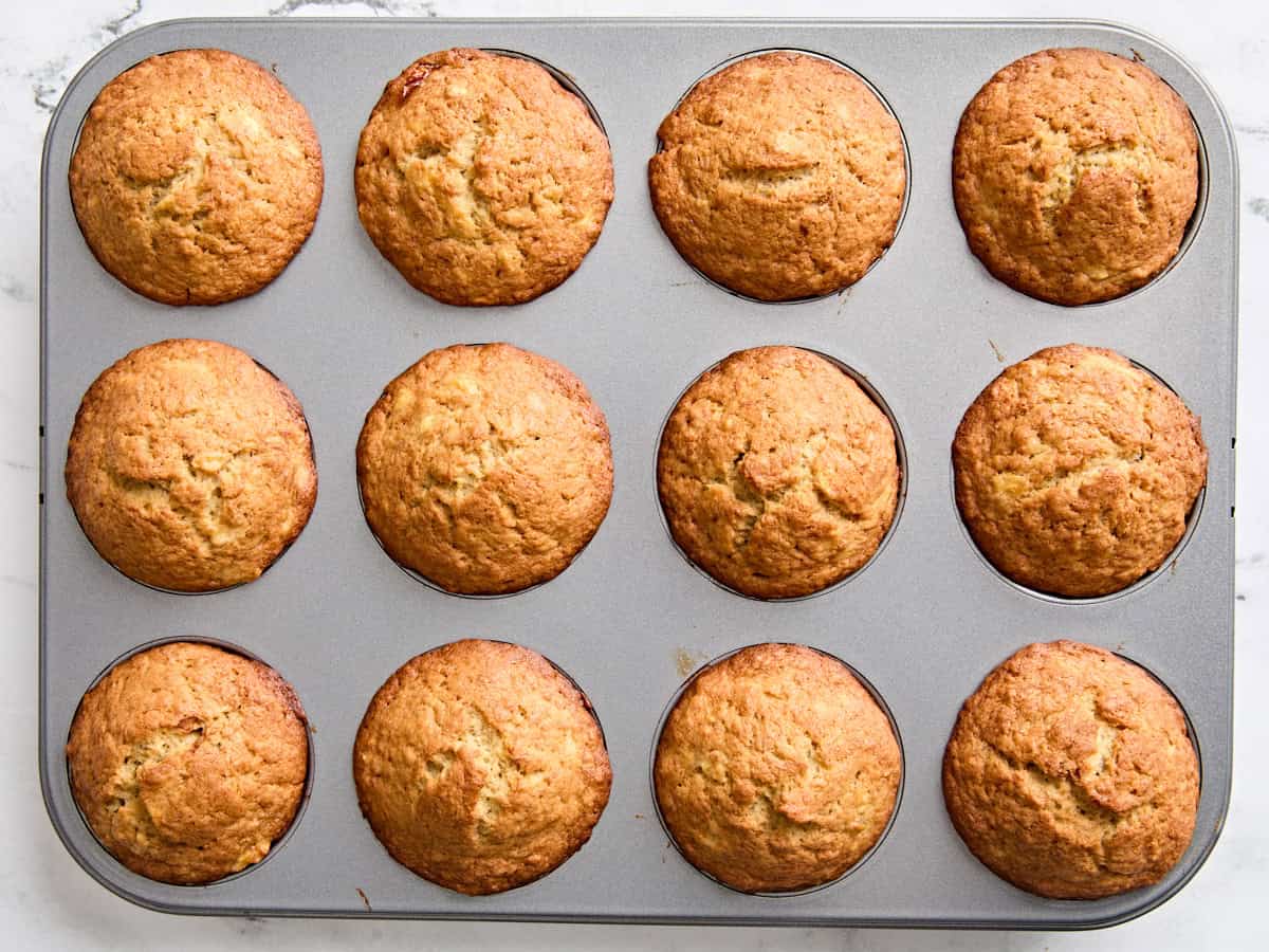 Freshly baked banana muffins in a muffin pan.