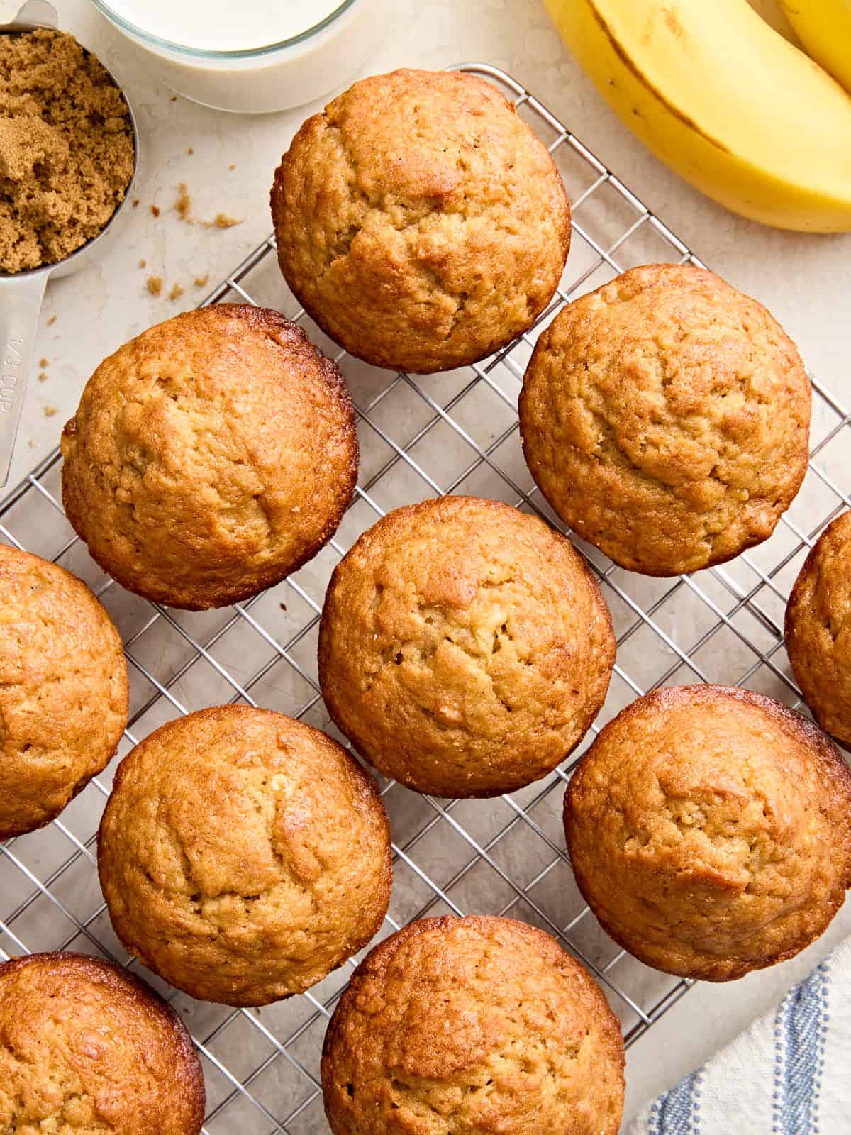 Overhead view of homemade banana muffins on a wire cooling rack.