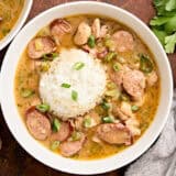 Overhead view of a bowl of gumbo and white rice.