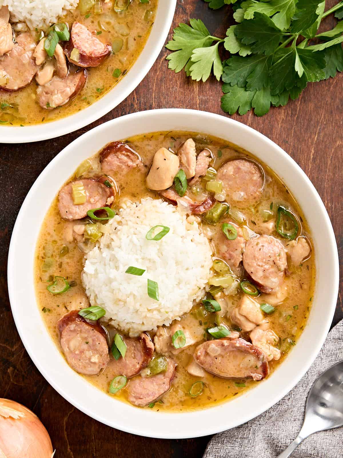 Overhead view of a bowl of gumbo and white rice.