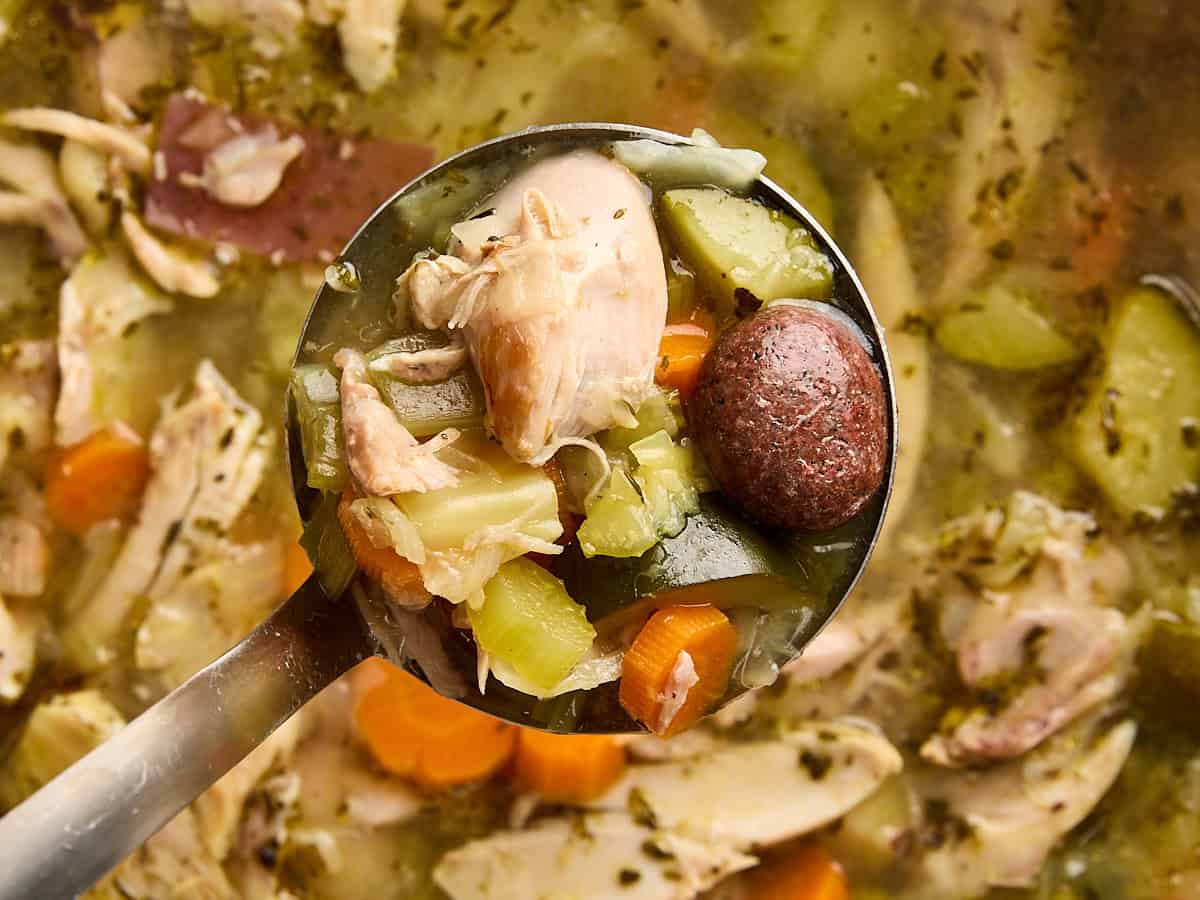 Overhead close up of stone soup in a ladle.